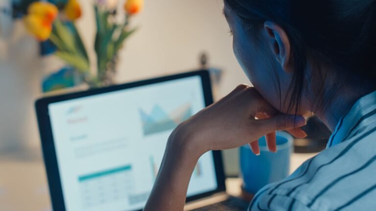 una mujer viendo una pantalla de ordenador con gráficos