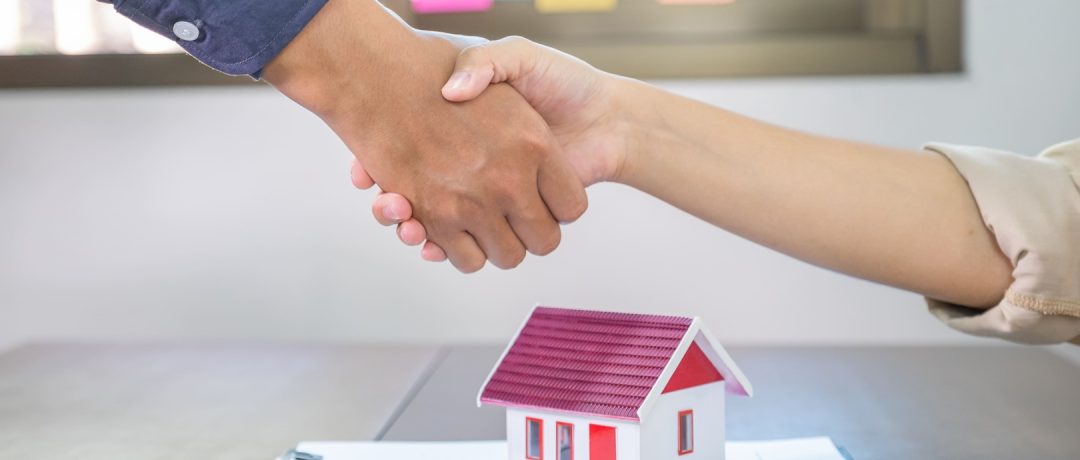 Dos personas cerrando un acuerdo inmobiliario